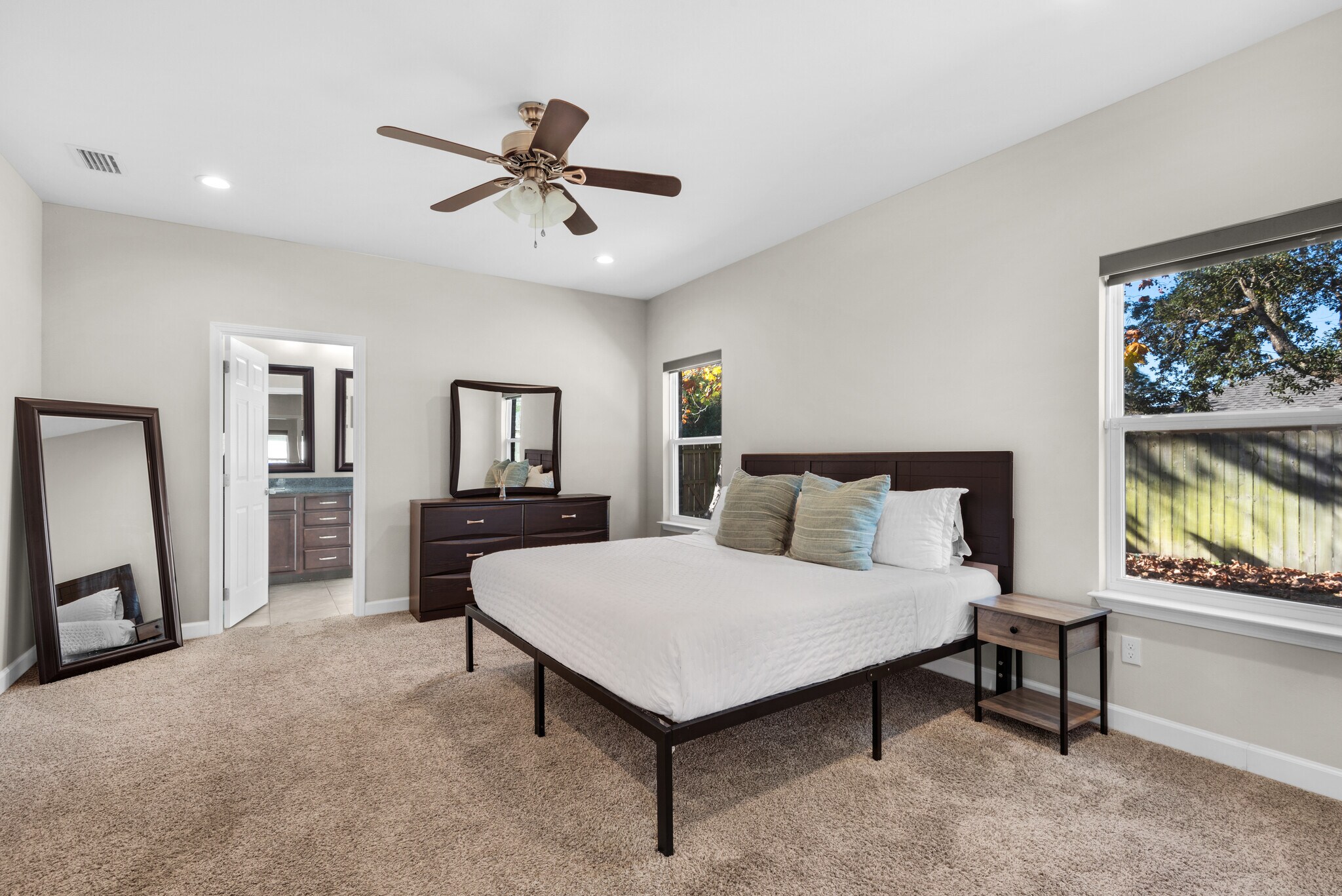 Master bedroom with cozy memory foam king bed, fresh linens, dressers, nightstands, and TV - 28 Snook Rd