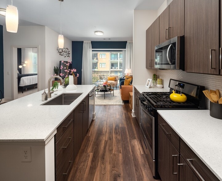 Counters run both walls, with the living room framed at the end of the run. - 675 N. Highland