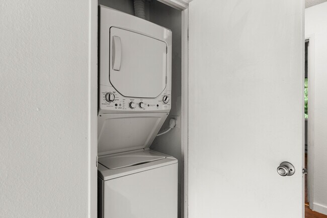 Streamline your chores with this space-saving laundry unit. - University Crossing Apartments