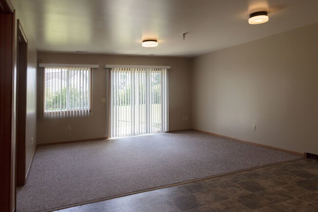 A living room in a two bedroom, one story apartment. - Legacy Creek Townhomes
