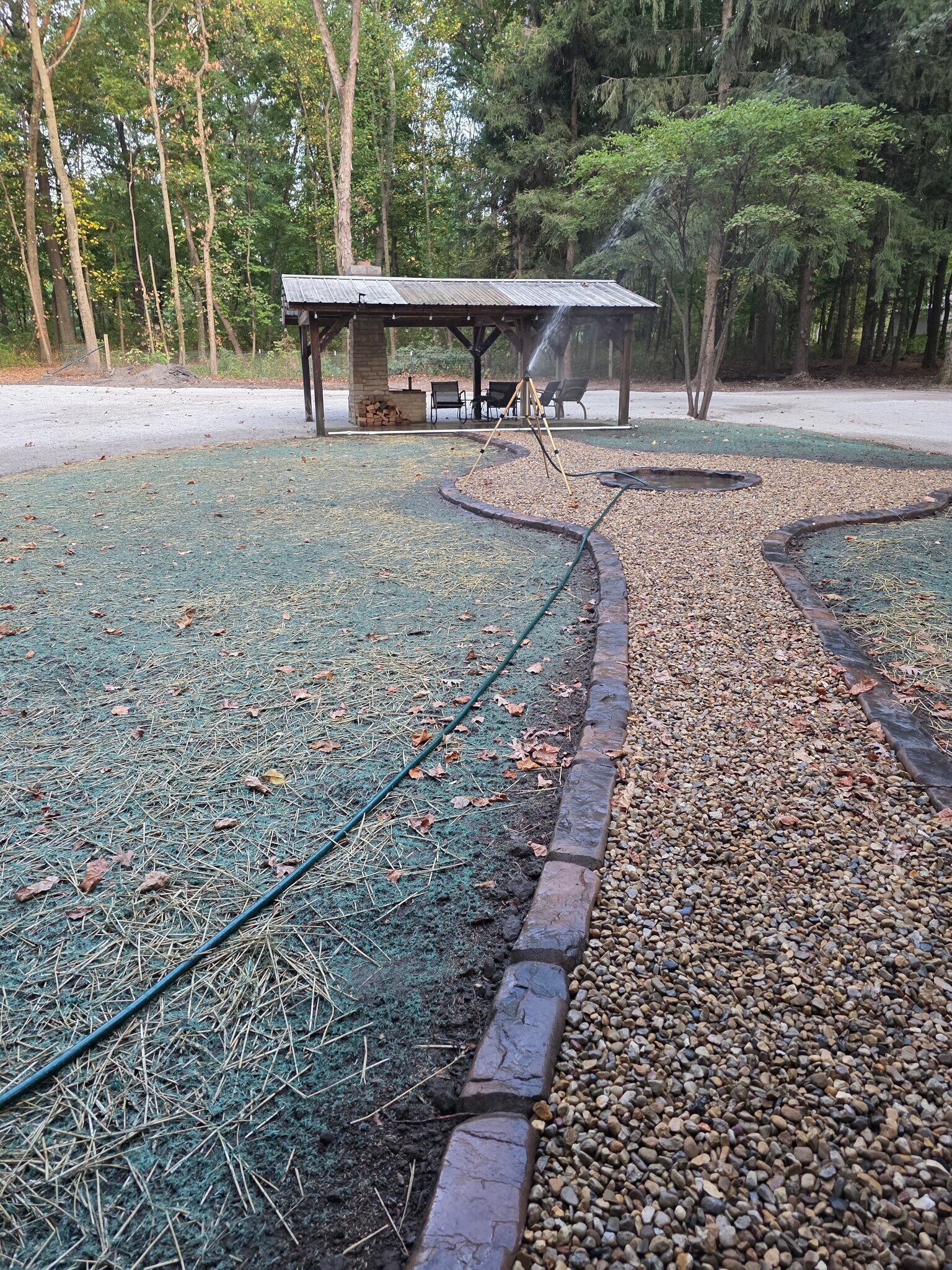Outdoor landscaping leads to fire pit and pavilion area - 1008 W Singing Woods Rd