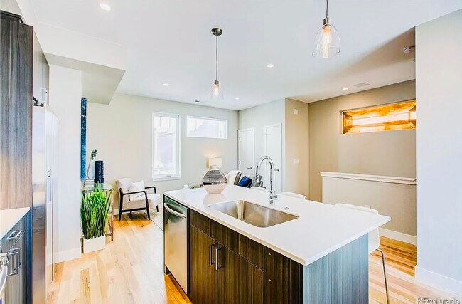 Experience the elegance of a contemporary kitchen joined seamlessly with a welcoming living area. - Harley House