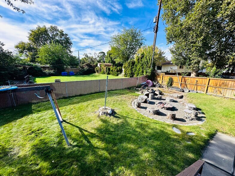 Backyard view with fire pit and garden area - 219 Thayer Dr