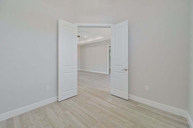 Building Photo - NOW AVAILABLE - Gorgeous Pool Home ~ NW Cape ~ 3 Car Garage ~ On Canal!