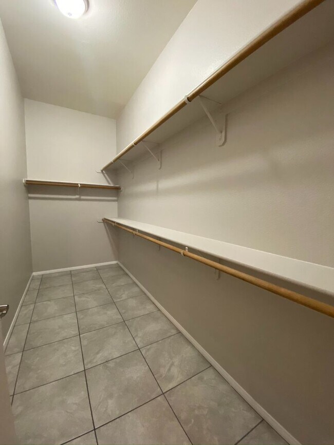 Building Photo - BEAUTIFUL CONDO IN A GATED COMMUNITY FEATURING PLANTATION SHUTTERS, TILE FLOORING AND NEW PAINT T...