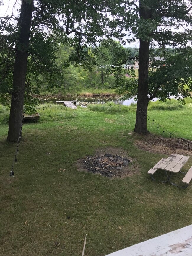 South view from upper deck with picnic table, firepit, canal and dock - 3645 Indian Lake Rd