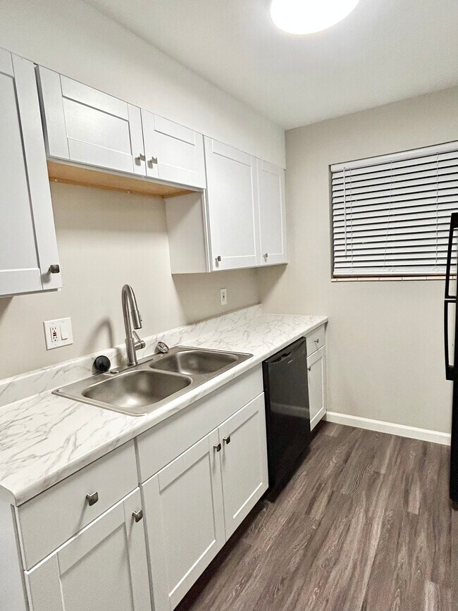 Explore this sleek kitchen space, designed for modern living and effortless entertaining. - GRACE LANDINGS APARTMENTS