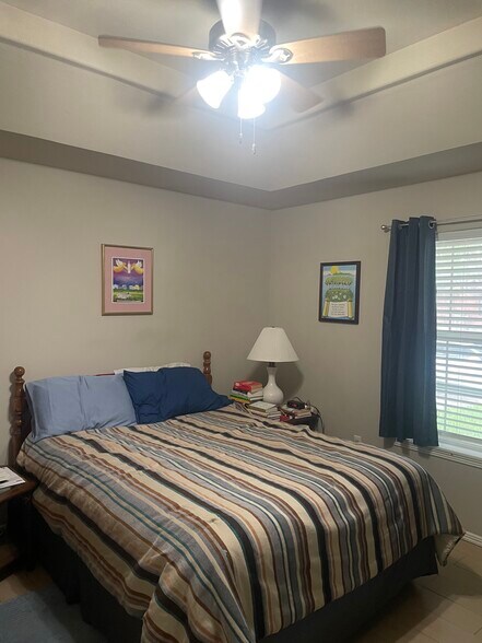 Master bedroom with queen bed, linens, comforter, night tables and lamps. - 2607 Ringold Cir