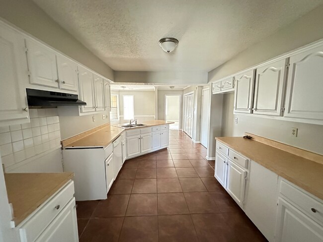 Building Photo - Grand 4BR/2BA Near Southwind | 2,438 Sq Ft, Stone Fireplace, Soaking Tub & 2-Car Garage