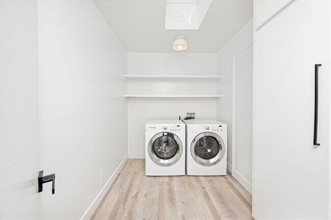 Spacious laundry room with plentiful shelving and oversized cabinets - 518 Euclid St