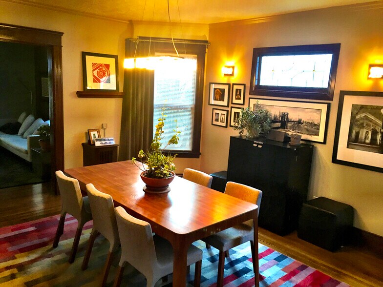 Dining Room with stained glass window and custom window coverings. - 565 Delta Avenue