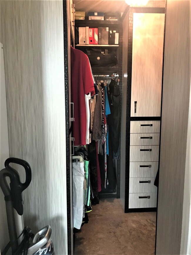 Master Closet with custom cabinets. - 15901 Collins Ave