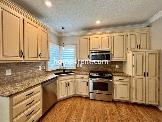 Building Photo - Updated Kitchen, Large Two Tiered Deck, Finished Basement in Blue Valley Schools!