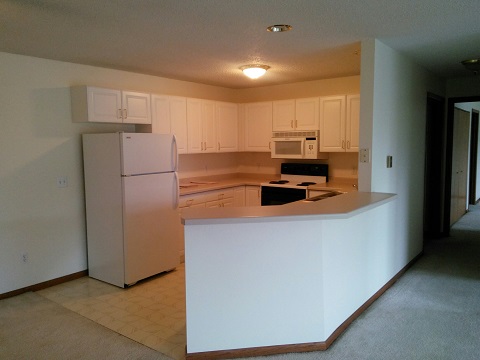 Kitchen with Breakfast Bar - River Ridge Apartments-Waupaca