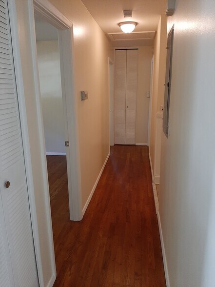 The main hallway leads to the 3 bedrooms & 1.5 bathrooms. Nest thermostat not shown. - 2955 Fantasy Ln