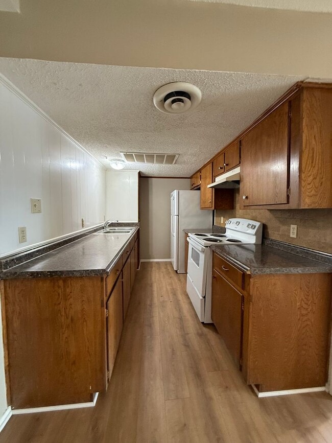 Building Photo - 1/1 NEW FLOORING ON-SITE LAUNDRY FACILITY-...