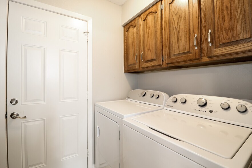 A matching Whirlpool washer and dryer set fill up the laundry room. The washer is large capacity, sh - 2507 Holt Road