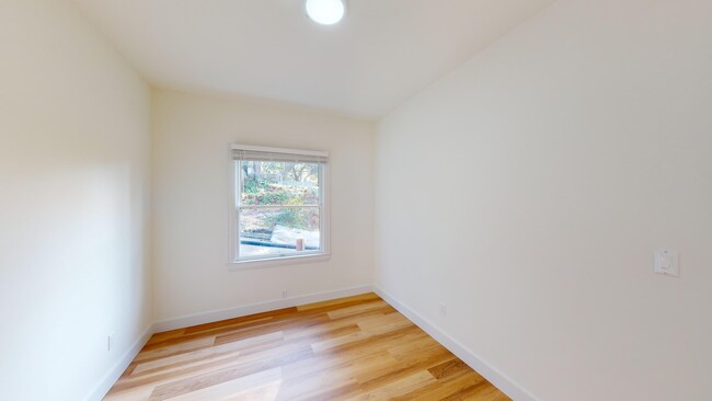 Bedroom with a window that allows natural light to filter in and floor that is made of wood - 1729 Arch Street