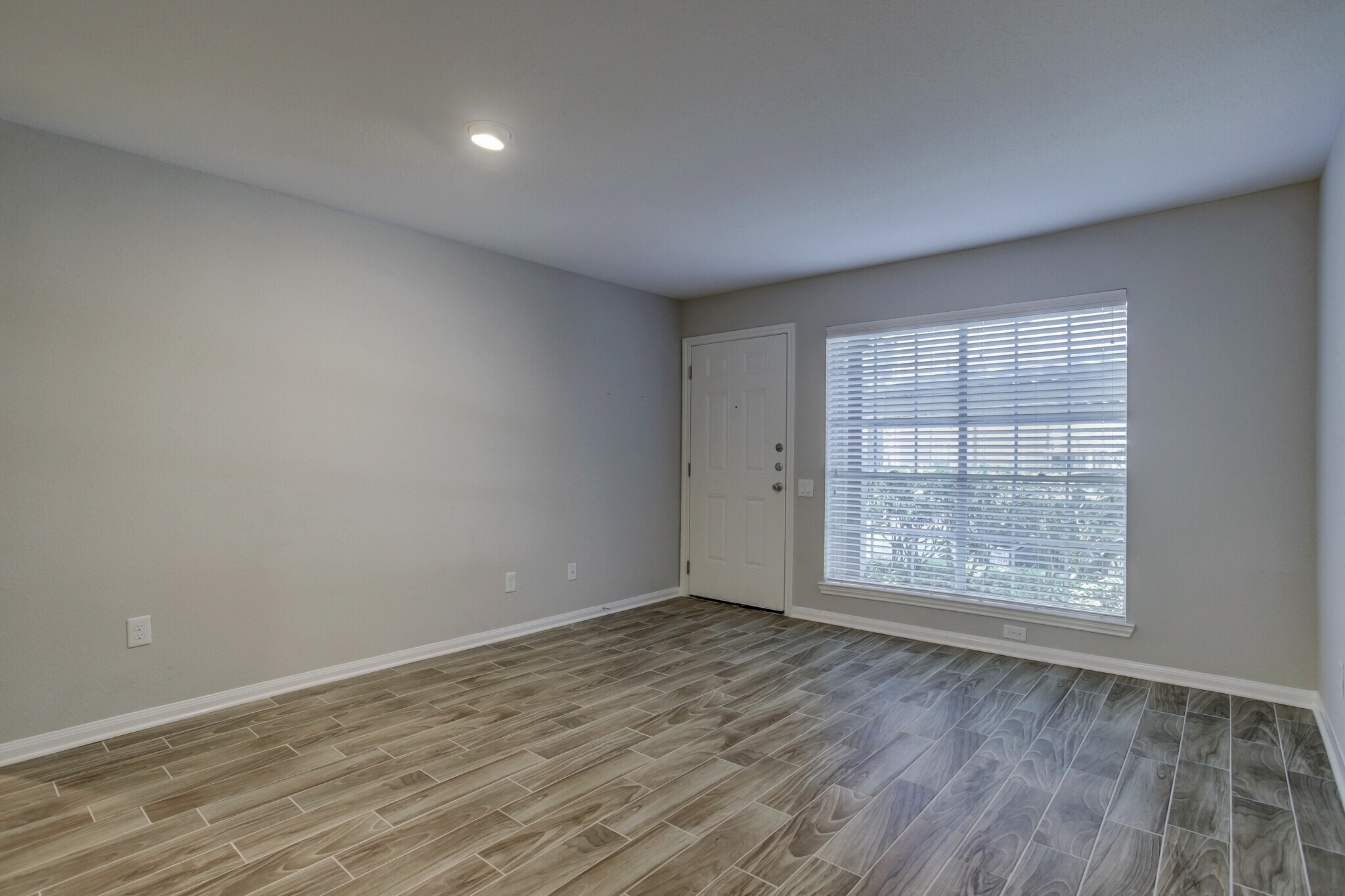 Spacious living room - looking out - view without furniture. - 1880 White Oak Dr. Apt 119