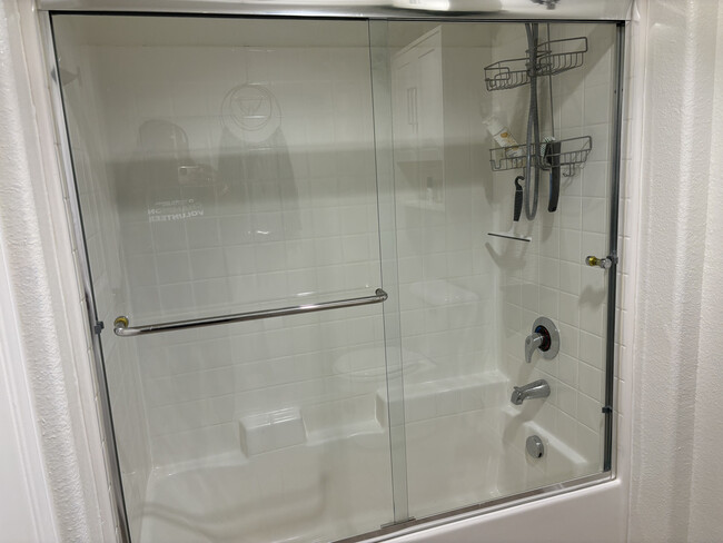 Modern bathroom featuring sliding glass shower doors and premium fixtures - your spa-like retreat - 3740 Santa Rosalia Dr