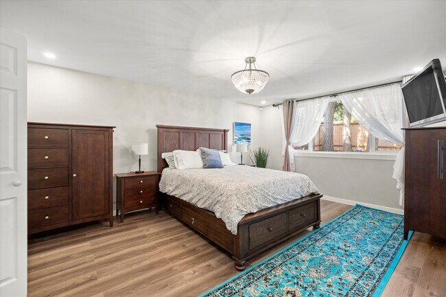 Incredibly spacious master bedroom with built in smart TV and en-suite master bathroom. - 4206 N Winnifred St