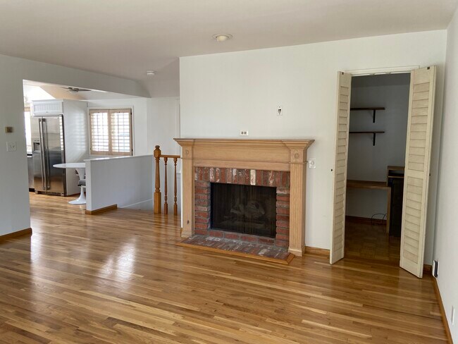 Living room, door to office, fireplace, view of kitchen - 317 7th St