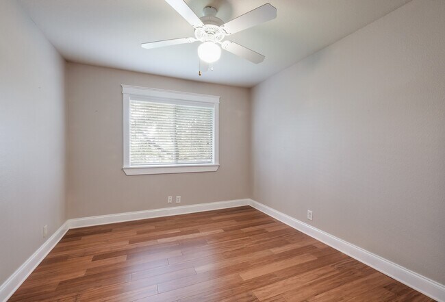 Building Photo - Modern Elegance: 3-Bedroom Townhome with Wood Flooring, Shaded Deck, and Inclusive Amenities