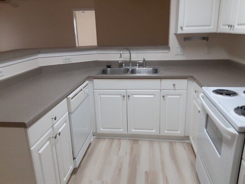 Kitchen with new flooring, has pantry closets for pantry and full-sized washer & dryer - 100 Kensington Blvd