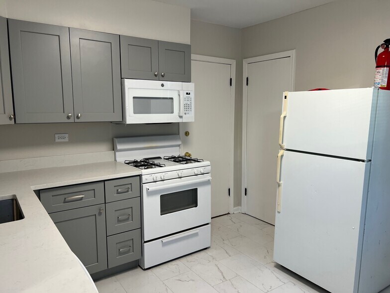 Kichen looking towards rear exit and storage closet - 812 Beloit Ave