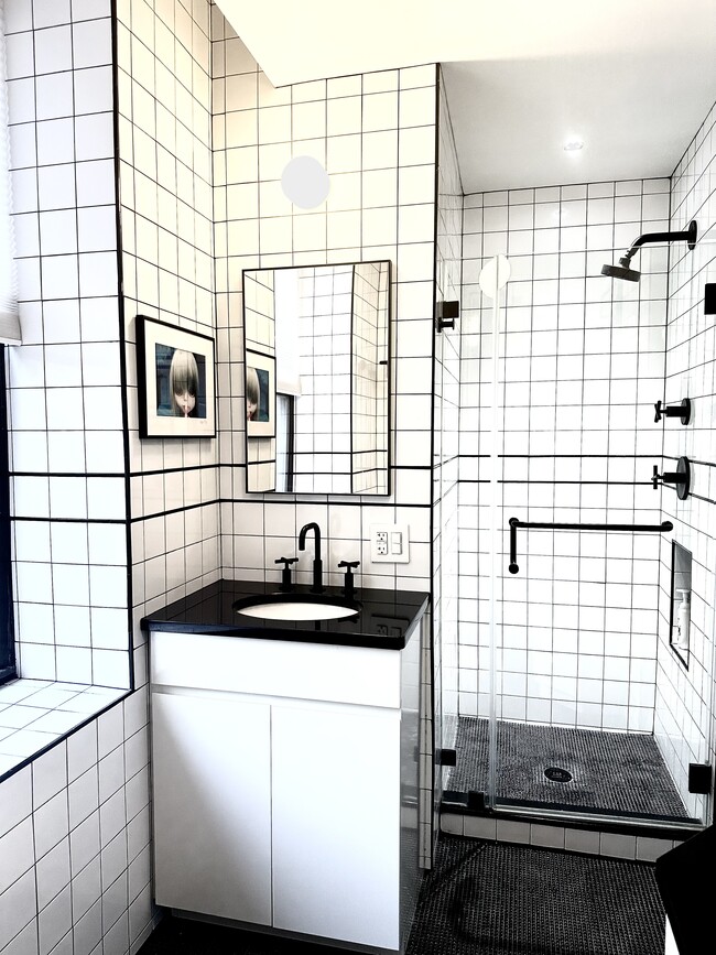 Sunfilled bathroom with water filtration in sink and shower - 790 Riverside Dr