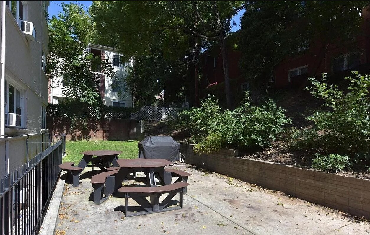 Back patio with grill and tables, shared by building residents - 2339 40th Pl NW