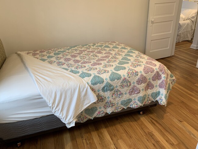 We place lovely quilts on our beds between the cotton sheets and comforter for extra comfort. - 1910 Evans Ave