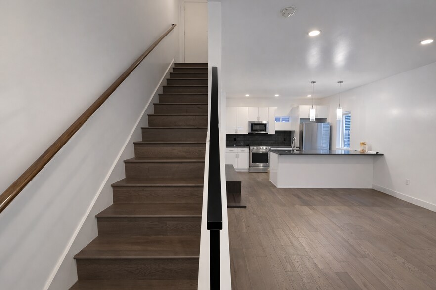 Elegant staircase with hardwood floors to level 2 - 1733 NW 63rd St