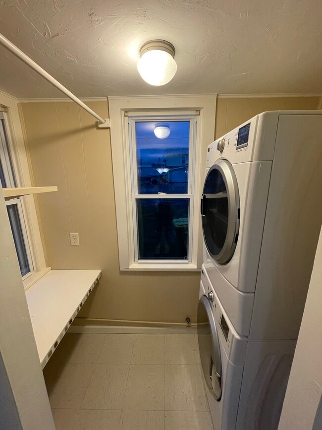 in-unit laundry nook with stackable washer and dryer - 2310 Old Berwick Rd