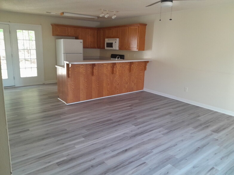Open living room/kitchen floor plan w/access to back patio - 136 Cedar Ave
