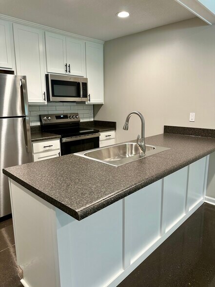 Plenty of cabinets, drawers, counter space, soft close feature - 2304 Belle Ave NE