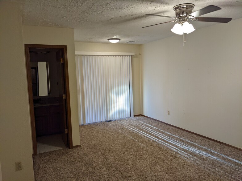 Master bedroom with privacy blinds and access to patio - 1618 Julie Plz