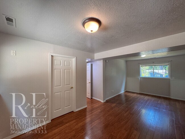 Building Photo - Freshly Painted East Bremerton Home with Expansive Decks & Flexible Living Space