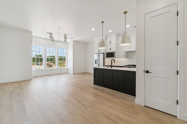 Building Photo - Bright. Clean. Calm. Your Elevated One-Bed...