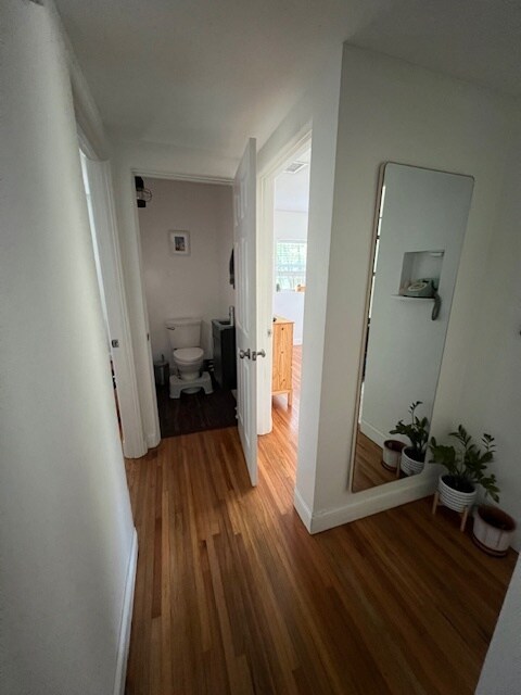 Hallway with half bathroom. - 30 W Par St