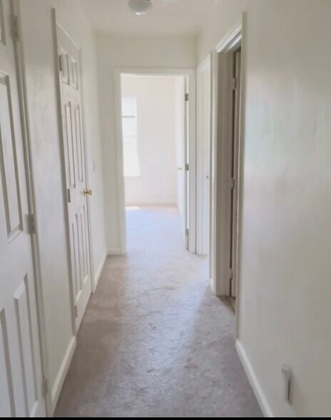 Upstairs hallway looking toward front bedrooms. Two large storage closets on left - 834 Patrick Henry Dr