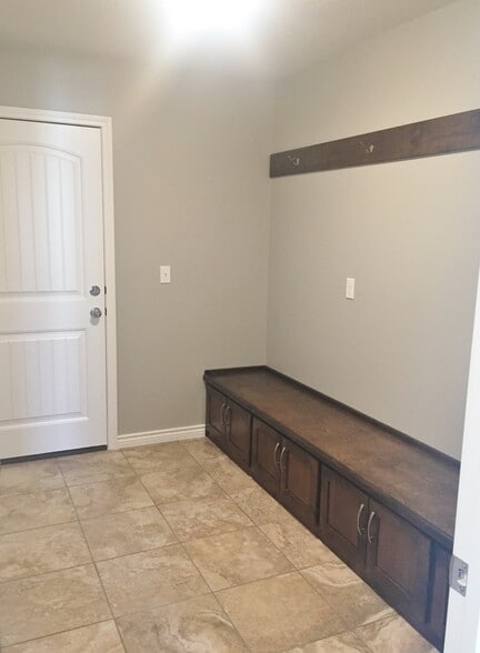 Mud room off of garage offers bench storage and coat hooks - 1614 College Street