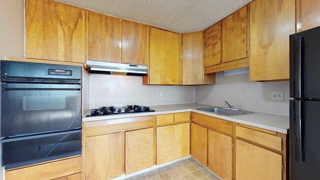Step into a kitchen designed for both style and practicality, perfect for culinary adventures. - Melody Apartments