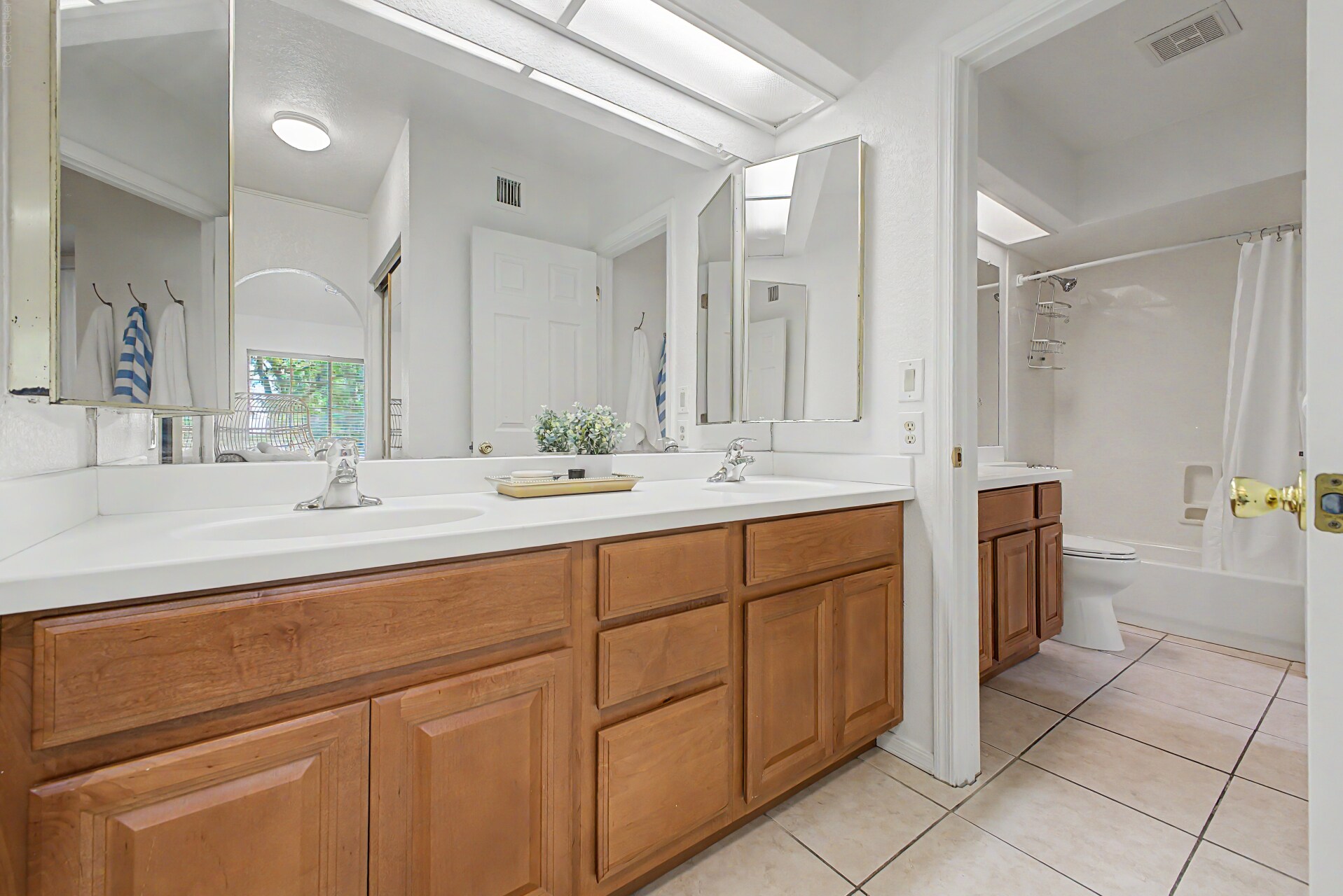 Dual-Sink En-Suite Bathroom in the primary bedroom upstairs - 819 N College Ave