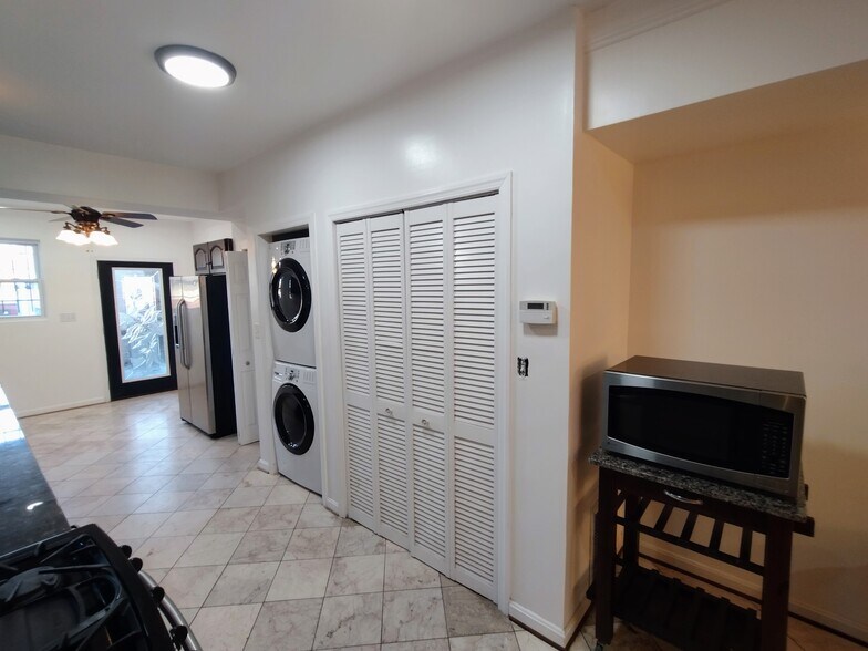 Kitchen (Opposite Side) Well-equipped kitchen featuring a refrigerator, washer and dryer, and microw - 1933 4th St NW