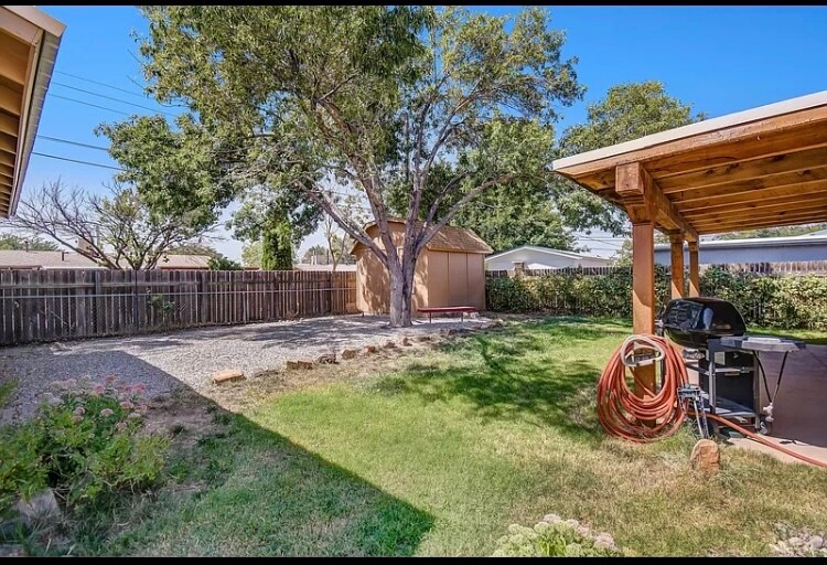 Private, landscaped, fenced yard with covered patio and storage building , detached garage - 11504 Mahlon Ave NE