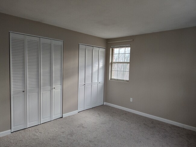 Master bedroom with new carpet, paint, closet doors, and baseboard - 9 Kenmar Dr