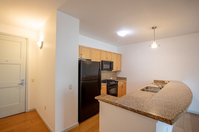 Building Photo - Sweet + secure 1/1 condo with parking, extra storage room + AC available now!