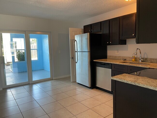 Eat-in kitchen with access to the covered patio - 7669 SE James St