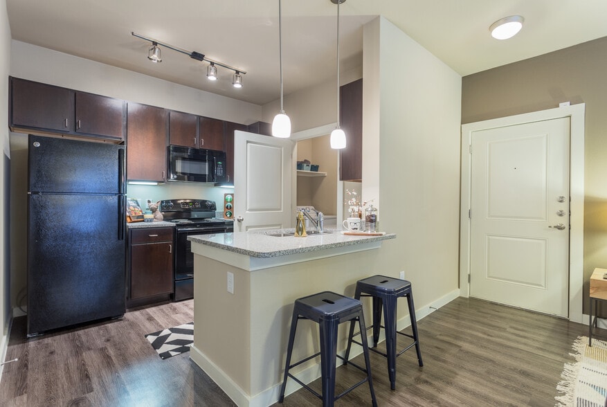 Kitchen bar and front entrance - Encore 281 Apartments